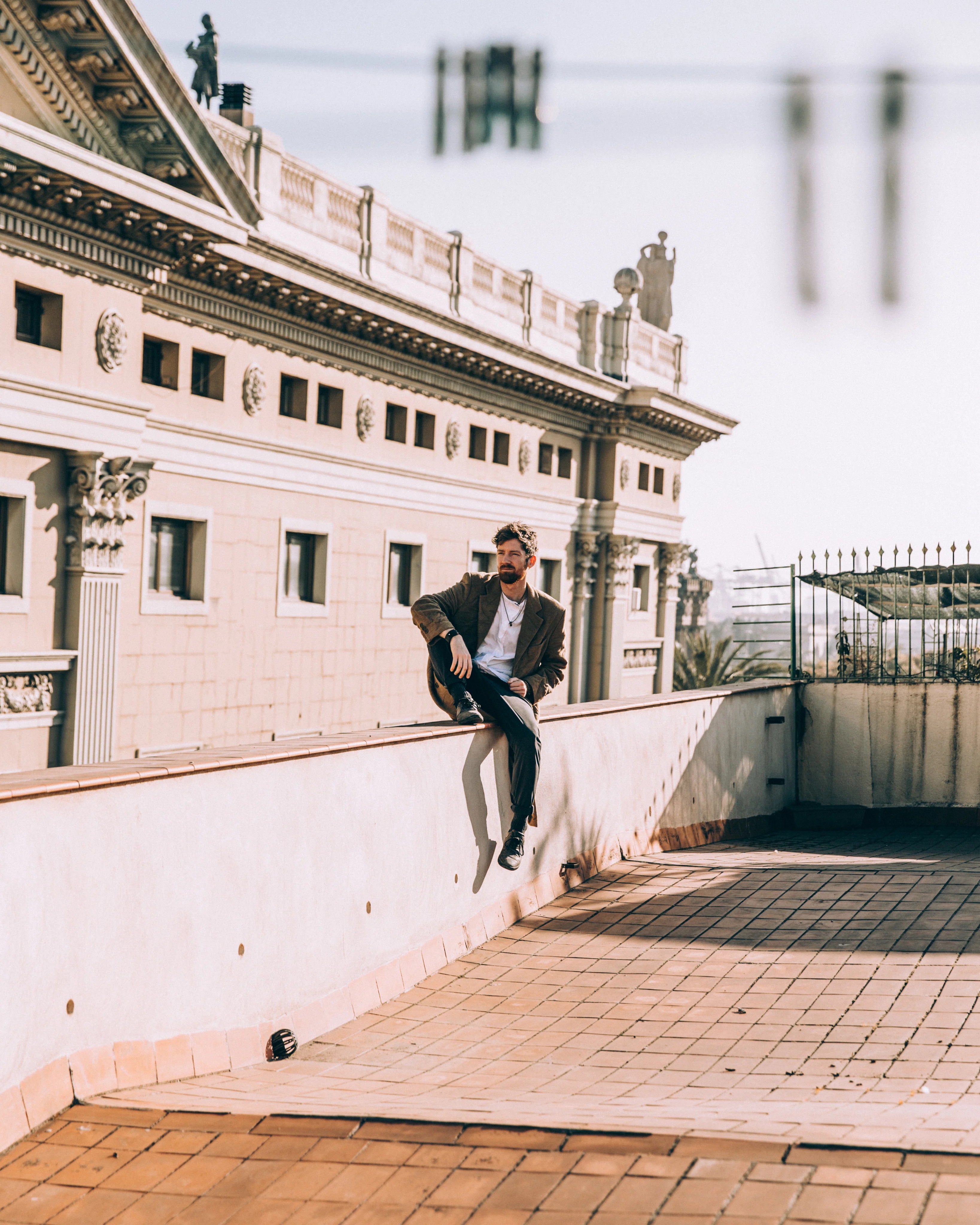 files/man-sit-casually-on-roof-ledge.webp